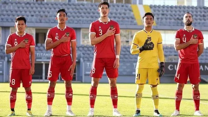 Indonesia vs Iran: Iranian team lineup on pitch with hands on hearts.
