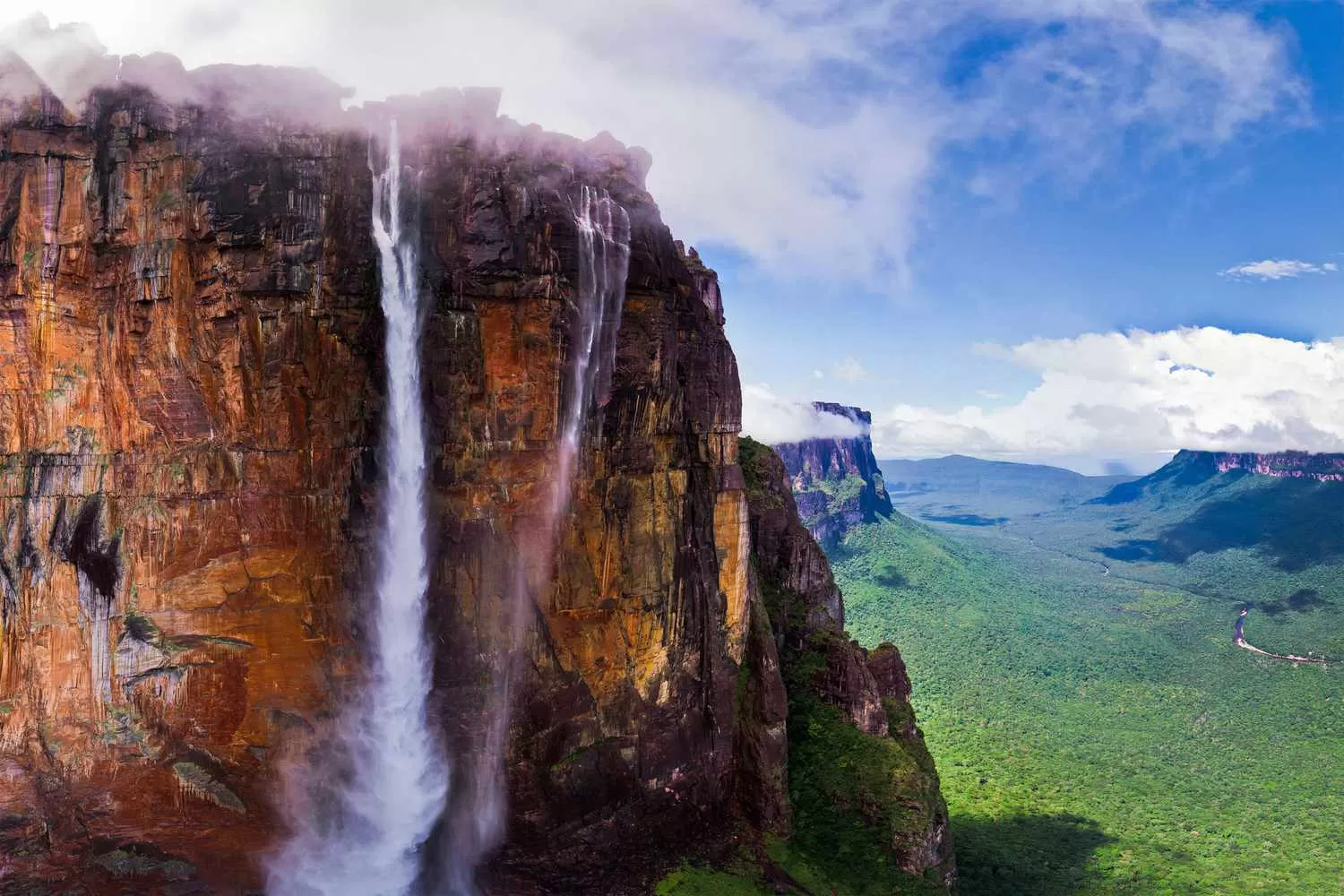 Aerial view of Angel Falls cascading from Auyán-tepui amidst lush Venezuelan rainforest.