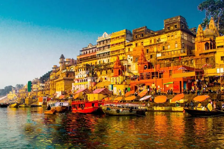 Aerial view of Varanasi, showcasing the winding lanes and the Ganges River, symbolizing the city's spiritual essence and rich cultural heritage.