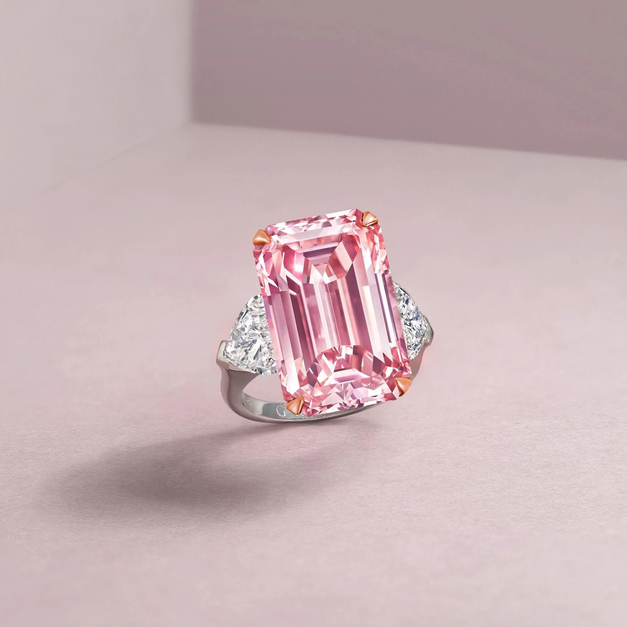 Laurence Graff holding the Graff Pink Diamond, showcasing its size and unique color.