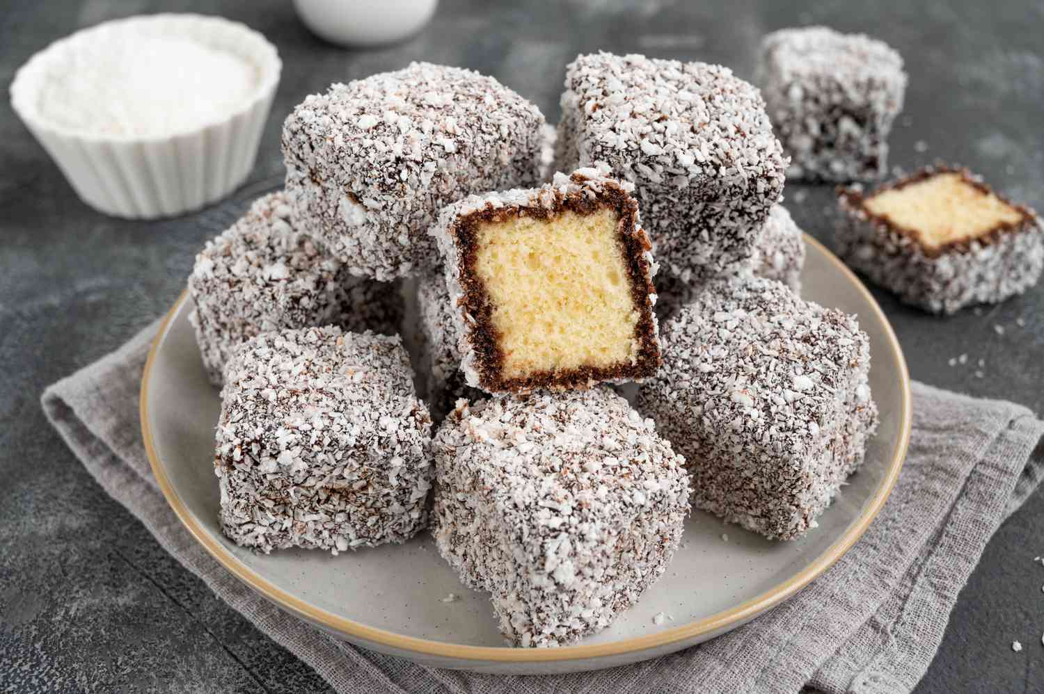  A platter of Lamingtons with fresh berries and whipped cream.