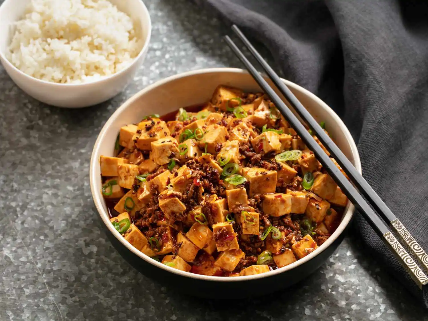 A steaming bowl of Ma Po Tofu with silken tofu cubes and minced pork