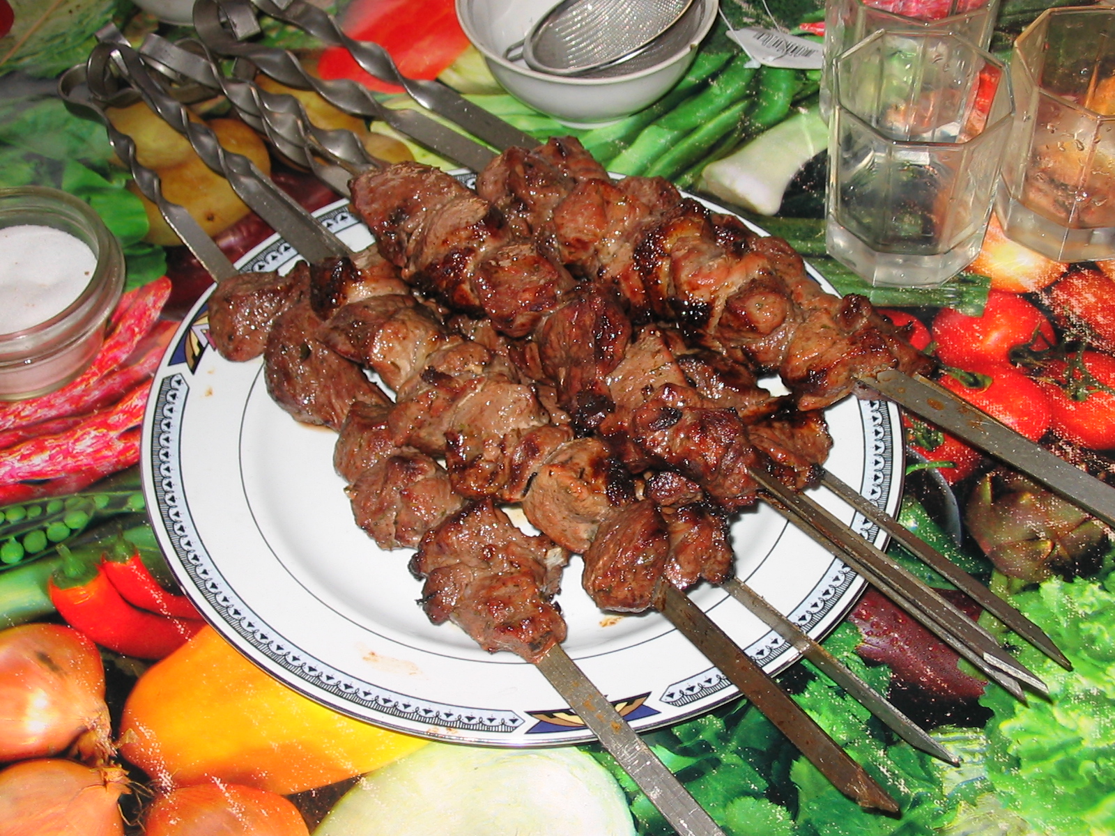 Juicy and tender shashlik skewers garnished with herbs. 