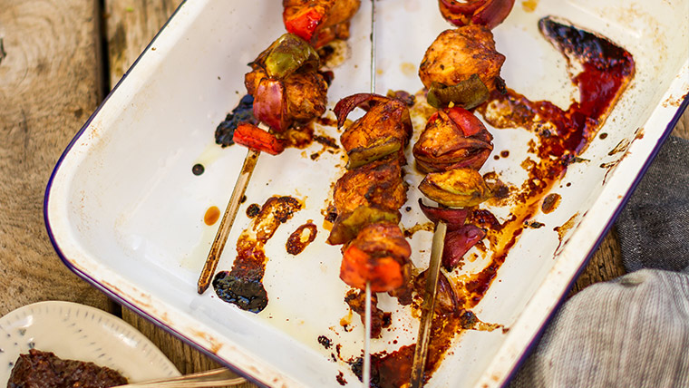 Skewers of perfectly grilled shashlik on a barbecue.