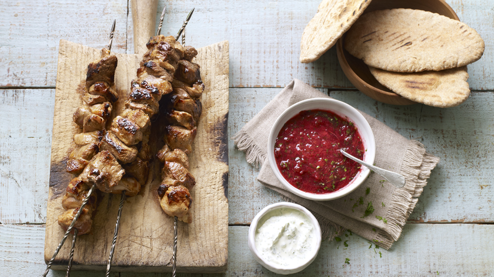 Shashlik marinated in a bowl with fresh herbs and spices. 